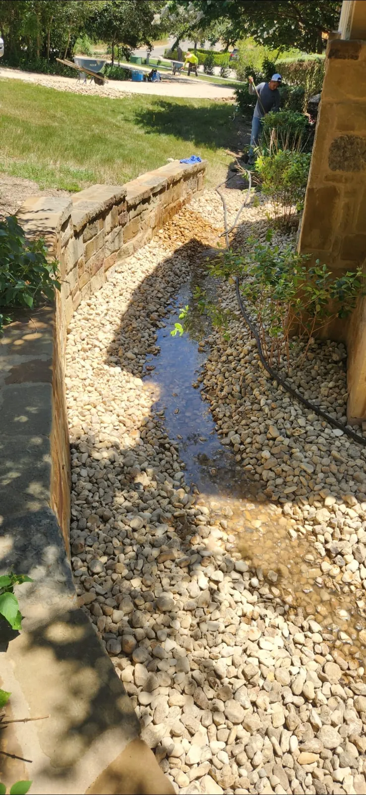 Rock drainage channel beside a garden structure